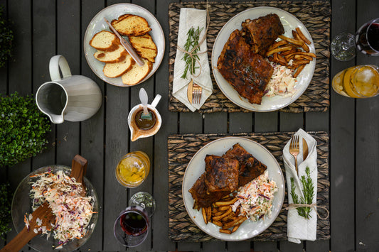 Smoked dinner ideas with plated meals served with sides in a casual outdoor setting